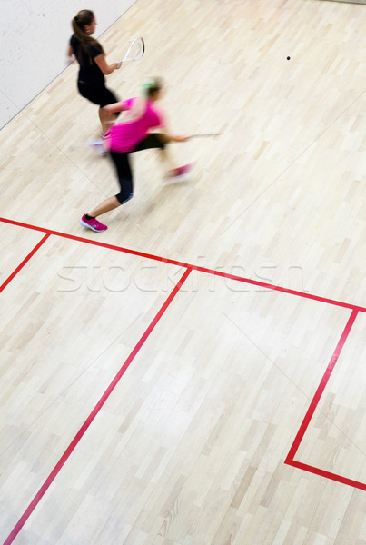 Two female squash players in fast action on a squash court (moti Stock photo © lightpoet