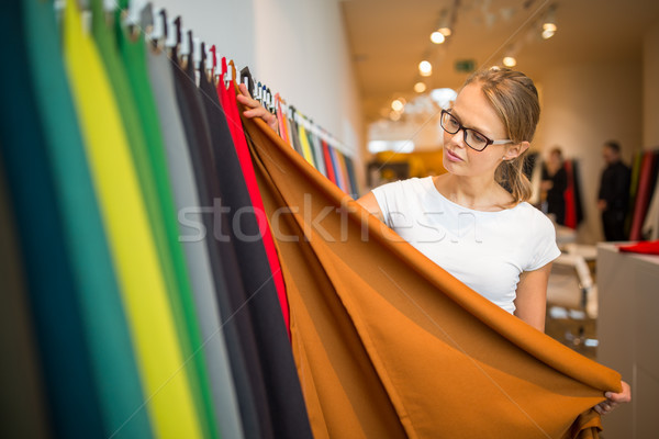 Pretty young woman  choosing the right material/color Stock photo © lightpoet