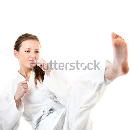 Beautiful caucasian, young, woman makes a kick in karate kimono  Stock photo © lightpoet