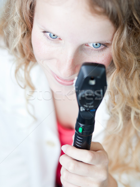 pretty female doctor/optometrist checking your eyes with an opht Stock photo © lightpoet