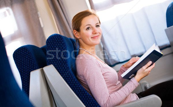Young woman reading a book while on a train Stock photo © lightpoet