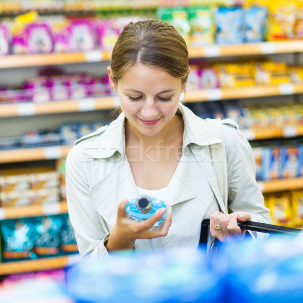 Stock photo: Beautiful young woman shopping in a grocery store/supermarket