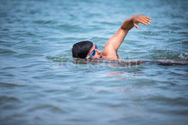 Triathlete man swimming freestyle crawl in ocean Stock photo © lightpoet