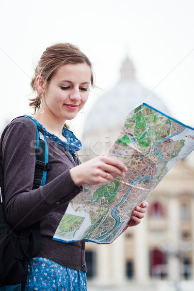Pretty young female tourist studying a map at St. Peter's square Stock photo © lightpoet