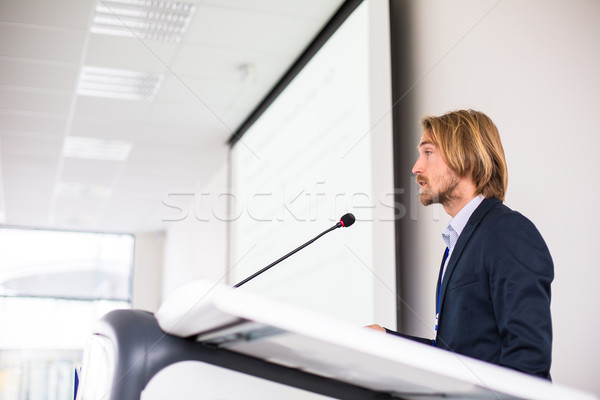 Handsome young man giving a speech at a conference Stock photo © lightpoet