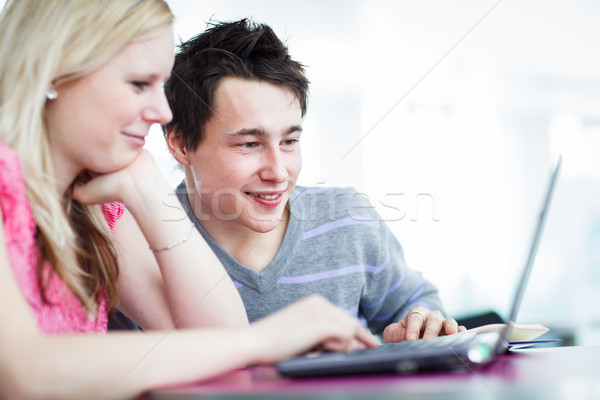 Two college students having fun studying together, using a lapto Stock photo © lightpoet