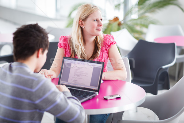 Two college students having fun studying together, using a lapto Stock photo © lightpoet