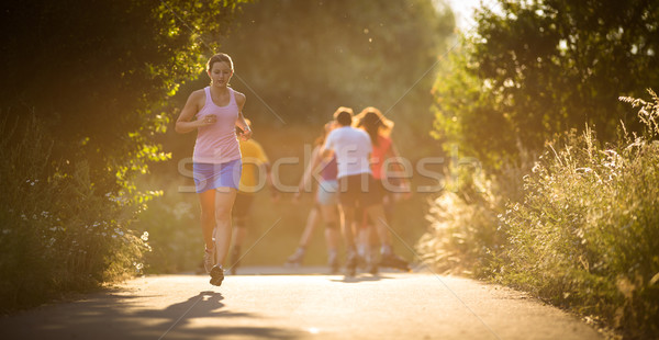 Young woman running outdoors on a lovely sunny summer evening  Stock photo © lightpoet