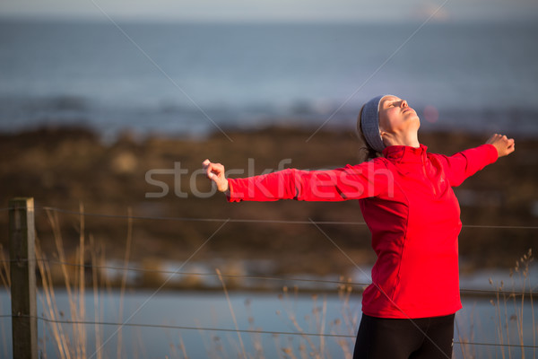 Young woman on her evening jog along the seacoast Stock photo © lightpoet