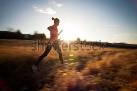 Young woman running outdoors on a lovely sunny winter/fall day  Stock photo © lightpoet