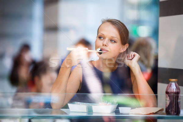Pretty, young womna eating sushi in a restaurant Stock photo © lightpoet
