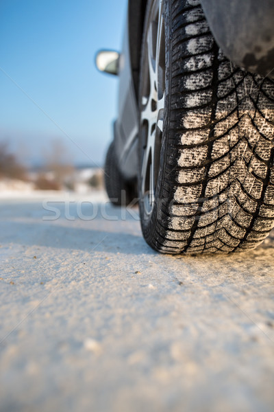 Car with winter tires on a slippery, snowy road Stock photo © lightpoet