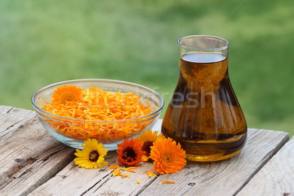 Calendula flowers and oil Stock photo © Lio22