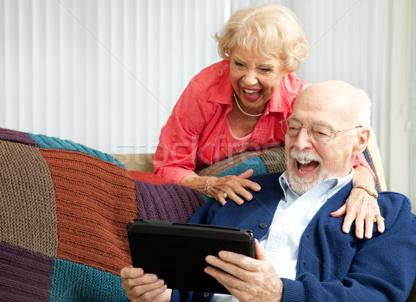 Casal de idosos risonho vídeo conversar computador Foto stock © lisafx