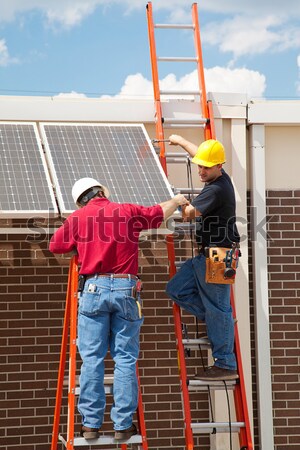 Energia słoneczna dwa pracowników panele słoneczne Zdjęcia stock © lisafx