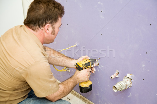 Carpenter Installs Drywall Stock photo © lisafx