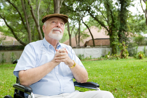Espiritual senior homem cadeira de rodas oração belo Foto stock © lisafx