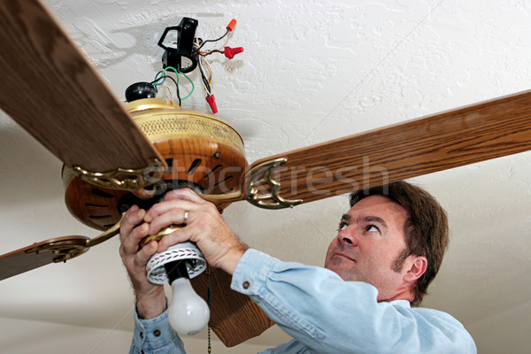 Electrician Removes Ceiling Fan Stock photo © lisafx