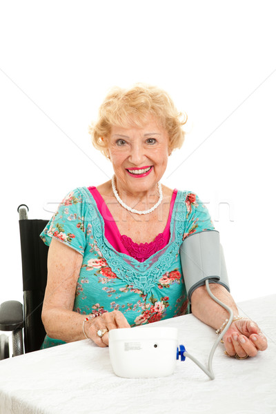 Woman Taking Her Own Blood Pressure Stock photo © lisafx