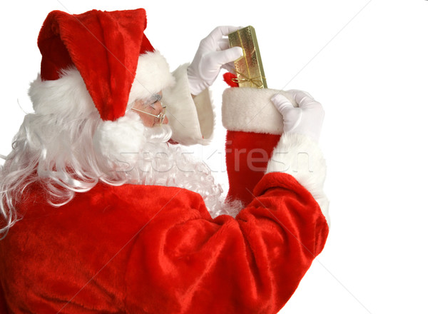 Stock photo: Santa Stuffs Stocking