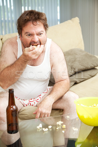 Kanapé krumpli pattogatott kukorica középkorú férfi otthon néz Stock fotó © lisafx