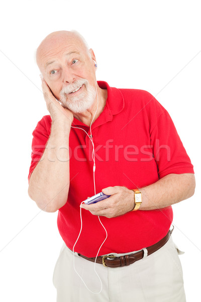 Starszy człowiek słuchania nowego mp3 player odizolowany Zdjęcia stock © lisafx