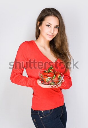 Cute thoughtful brunette with strawberries. Stock photo © lithian