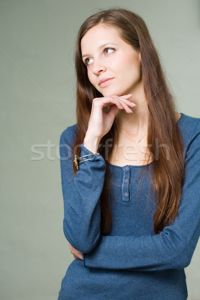 Pretty young student girl pondering. Stock photo © lithian