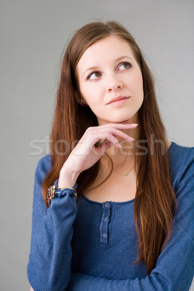 Pretty young student girl pondering. Stock photo © lithian