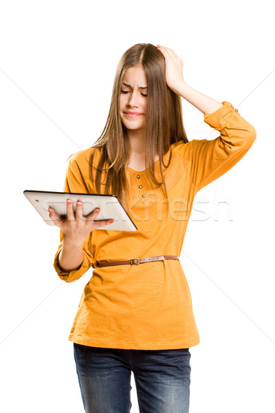 Teen girl using tablet computer. Stock photo © lithian