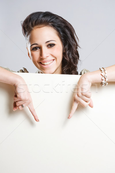 Attractive young brunette holding blank billboard. Stock photo © lithian