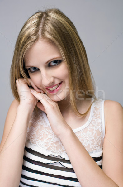 Young blond beauty with mischievious smile. Stock photo © lithian