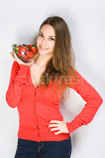 Stock photo: Fit young brunette with strawberries.