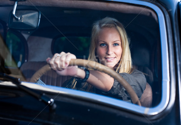 Beautiful young blond girl  in a black vintage car. Stock photo © lithian