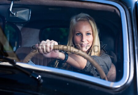 Beautiful young blond girl  in a black vintage car. Stock photo © lithian