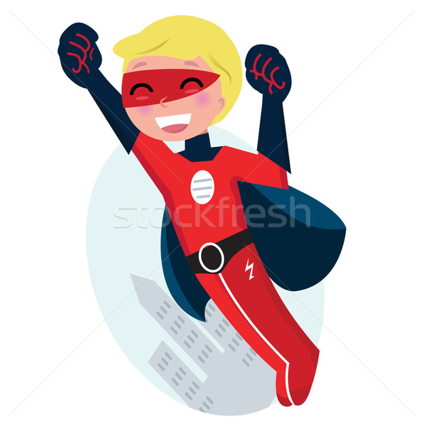 Stock photo: Cute flying superhero boy with city silhouette behind