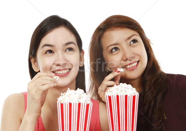 Popcorn filmów dwa młodych kobiet jedzenie oglądania Zdjęcia stock © lorenzodelacosta