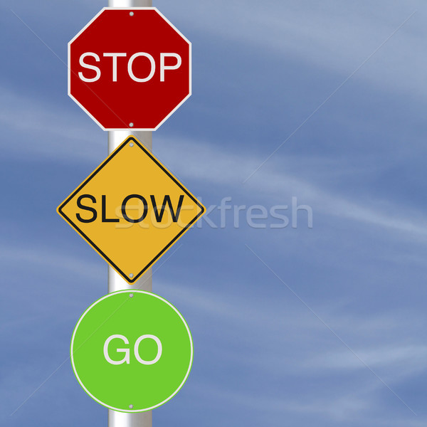 Stop lassú színes jelzőtáblák égbolt zöld Stock fotó © lorenzodelacosta