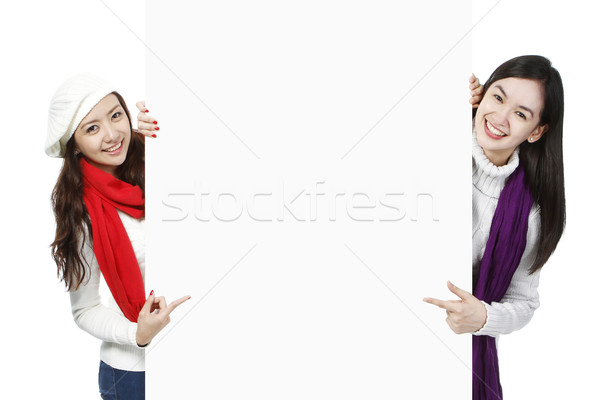 Young Women Pointing At Blank Space  Stock photo © lorenzodelacosta