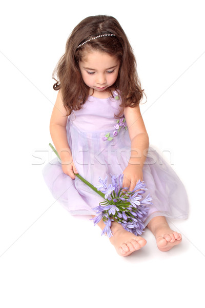 Little girl playing with a flower Stock photo © lovleah