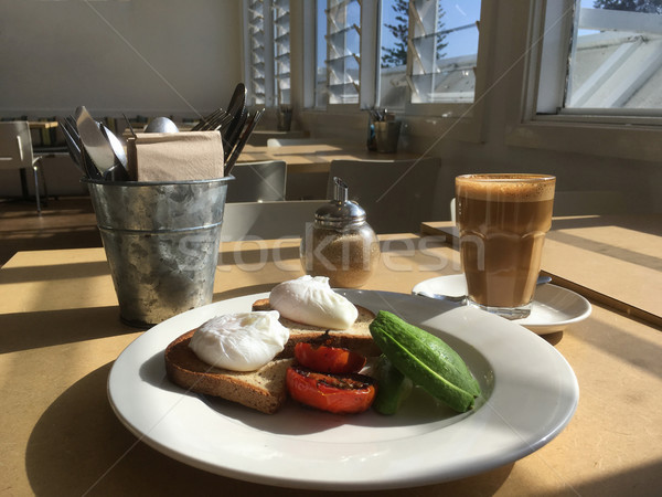 Poached eggs avocado and char-grilled tomato with latte at cafe Stock photo © lovleah