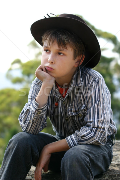 Country cowboy sitting on a rock Stock photo © lovleah