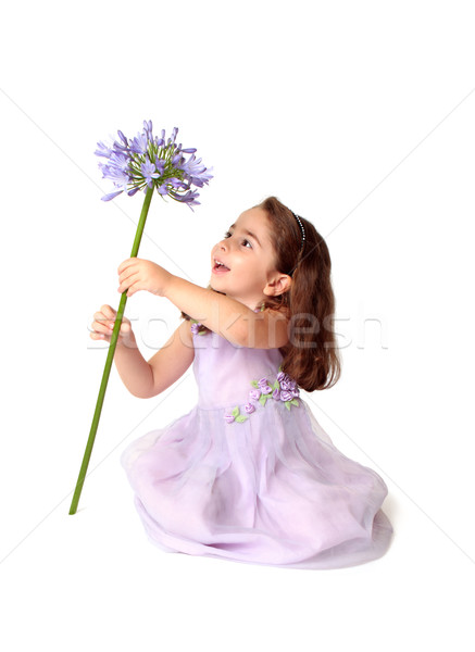 Little girl spinning a large stemmed flower with delight Stock photo © lovleah
