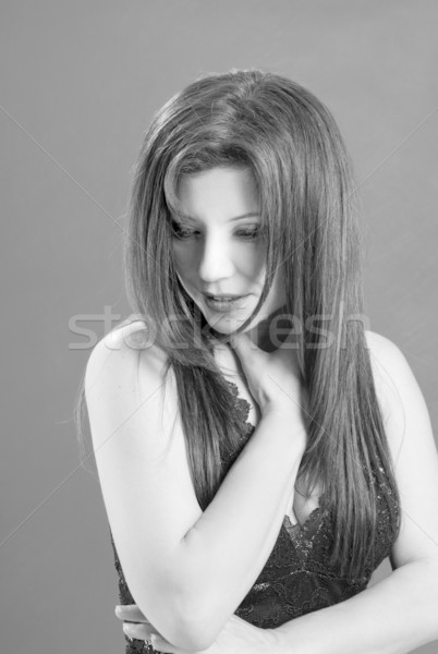 Beautiful woman gazing down Stock photo © lovleah
