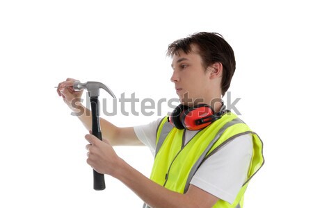 Teenager using a hammer and nail Stock photo © lovleah