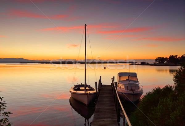 Boats moored to jetty at sunrise Stock photo © lovleah