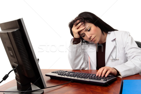 Overworked tired doctor at computer Stock photo © lovleah