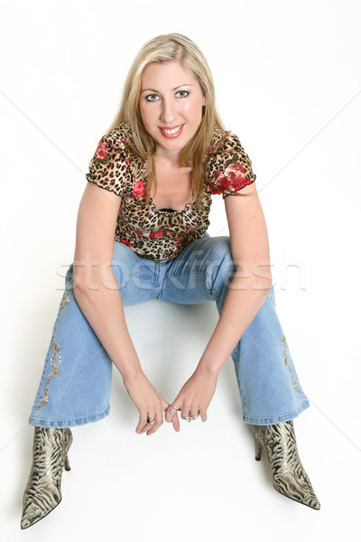 Sexy jeans vrouw vergadering vloer mooie vrouw Stockfoto © lovleah