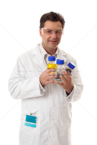 Laboratory chemist holding bottles of chemicals Stock photo © lovleah