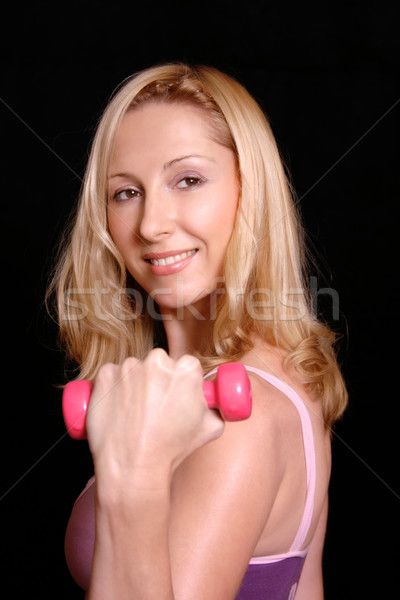 Smiling woman toning muscles Stock photo © lovleah